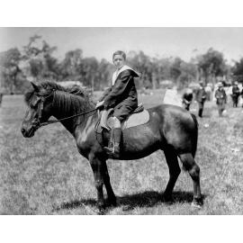 Horse in sport and competition : a boy riding a pony at Jubilee Oval