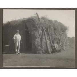 'Black Charlie' by a hut