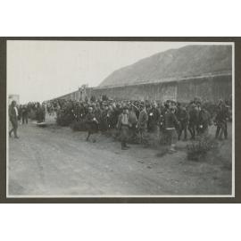 Townspeople gathered by a wall