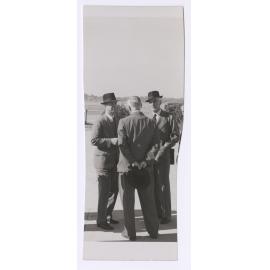 Three men talking together